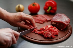 Cut the meat into thin slices and then chop as fine as possible.