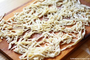 Gently shake off excess flour from the noodles and spread them out.